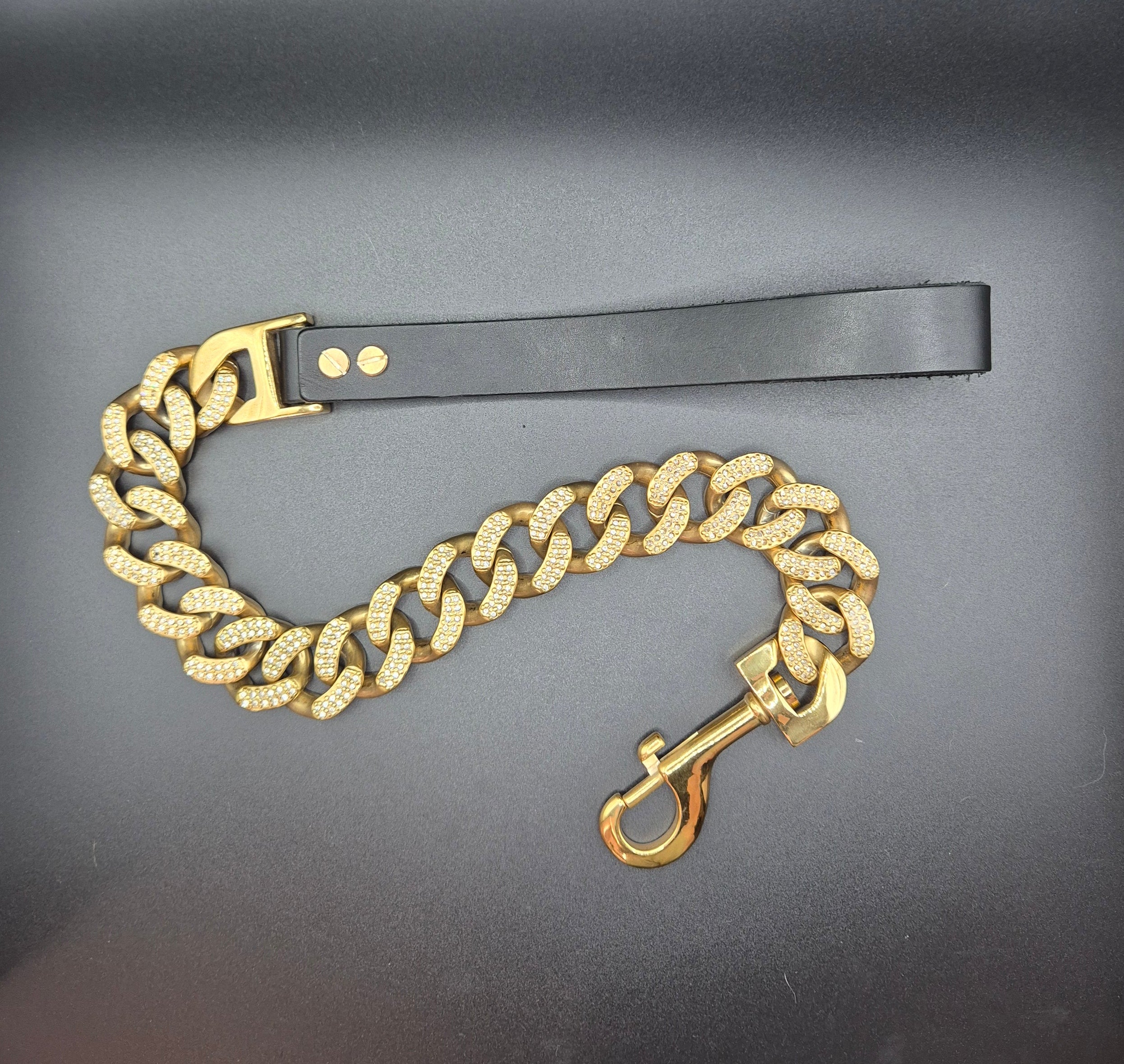 Gold chain with a clasp on a black surface