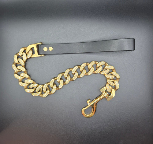 Gold chain with a clasp on a black surface