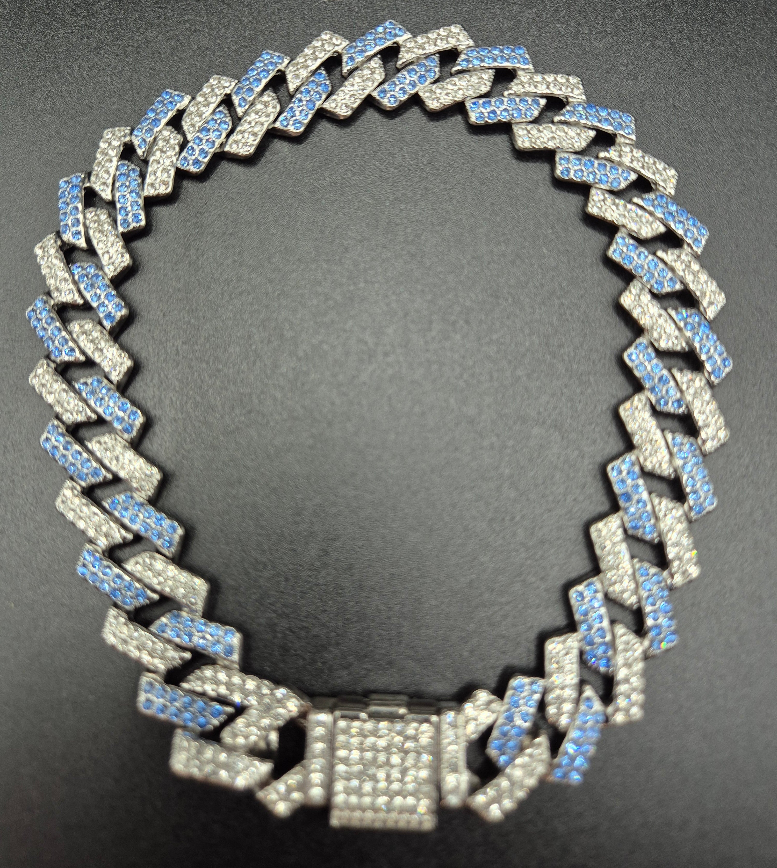 Silver chain necklace on a dark background